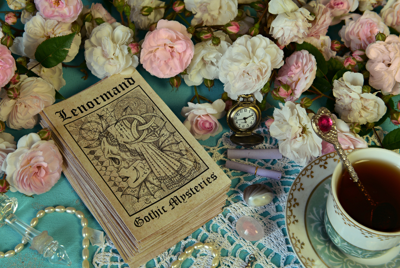 Still life with Lenormand tarot cards, roses and cup.